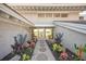 Ocean views are visible through the glass entryway, which is flanked by lush landscaping at 5 N Casey Key Rd, Osprey, FL 34229