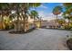 Beach house exterior view at dusk showcasing landscaping and lighting at 5 N Casey Key Rd, Osprey, FL 34229