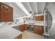 Modern kitchen with white counters and wood cabinets at 5 N Casey Key Rd, Osprey, FL 34229