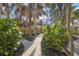 Landscaped pathway winds through lush tropical foliage at 5 N Casey Key Rd, Osprey, FL 34229