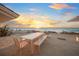 Beachfront patio dining at sunset at 5 N Casey Key Rd, Osprey, FL 34229