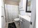 Clean bathroom with shower/tub combo, gray vanity, and patterned shower curtain at 8771 Trionfo Ave, North Port, FL 34287