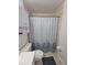 Bathroom with shower/tub combo and patterned shower curtain at 8771 Trionfo Ave, North Port, FL 34287