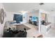 Living room with open concept floor plan, looking toward kitchen and entryway at 8771 Trionfo Ave, North Port, FL 34287