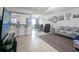 Bright living room with open floor plan, featuring a view into the kitchen and dining area at 8771 Trionfo Ave, North Port, FL 34287