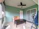 Relaxing screened porch with seating and ceiling fan at 8771 Trionfo Ave, North Port, FL 34287