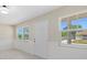 Light-filled entryway with white door and wood-look floors at 2616 Osage Rd, Venice, FL 34293