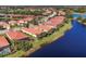 Community aerial view showcasing a collection of homes near a lake at 329 Savona Way, North Venice, FL 34275