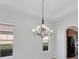 Bright dining room featuring a beautiful chandelier and views of the backyard at 329 Savona Way, North Venice, FL 34275