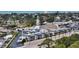 Aerial view of a condo building near the beach with parking and nearby businesses at 708 Tamiami S Trl # 308, Venice, FL 34285