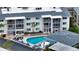 Aerial view of condo complex with pool, showing building and parking at 708 Tamiami S Trl # 308, Venice, FL 34285