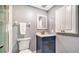 Updated bathroom with gray walls, navy vanity, and gold fixtures at 708 Tamiami S Trl # 308, Venice, FL 34285