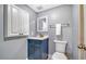 Small bathroom with navy vanity, marble countertop, and shower at 708 Tamiami S Trl # 308, Venice, FL 34285