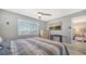 Main bedroom with large TV, ceiling fan, and view of ocean at 708 Tamiami S Trl # 308, Venice, FL 34285