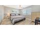 Comfortable bedroom with striped bedding and wood-look flooring at 708 Tamiami S Trl # 308, Venice, FL 34285