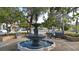 Relaxing park scene featuring a charming fountain and a person resting on a bench at 708 Tamiami S Trl # 308, Venice, FL 34285