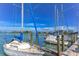 Several sailboats are docked at a marina on a sunny day at 708 Tamiami S Trl # 308, Venice, FL 34285