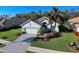 Single-Gathering home with a paved driveway and landscaped yard at 381 Marsh Creek Rd, Venice, FL 34292