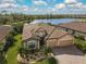 Two-story house with tile roof and two-car garage, lake view at 13587 Vancanza Dr, Venice, FL 34293