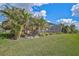 Screened patio, lush landscaping, and spacious grassy area at 13587 Vancanza Dr, Venice, FL 34293