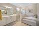 Elegant bathroom with a soaking tub, separate shower, and double vanity at 13587 Vancanza Dr, Venice, FL 34293