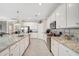 Modern kitchen with white cabinets and granite countertops at 13587 Vancanza Dr, Venice, FL 34293