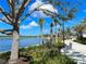 Scenic lakeside walkway with lush landscaping and seating areas at 13587 Vancanza Dr, Venice, FL 34293