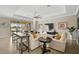 Living room with light-colored sofas, a long console table, and a large TV at 13587 Vancanza Dr, Venice, FL 34293