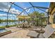 Relaxing poolside patio with seating and a lake view at 13587 Vancanza Dr, Venice, FL 34293