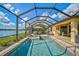 Enclosed pool and spa with patio furniture and lake view at 13587 Vancanza Dr, Venice, FL 34293