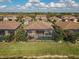 Aerial view of a home with a screened-in pool and patio at 13587 Vancanza Dr, Venice, FL 34293