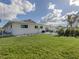 Wide open backyard featuring a well-manicured lawn, white privacy fence, and a rear elevation at 514 Palm Ave, Nokomis, FL 34275