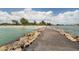 Picturesque beach view featuring a charming boardwalk leading to pristine sands and turquoise water at 514 Palm Ave, Nokomis, FL 34275