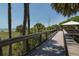 Scenic boardwalk view with lush tropical foliage and glimpses of the beach and ocean beyond at 514 Palm Ave, Nokomis, FL 34275