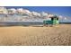 Quaint lifeguard station on a serene beach with soft sand and clear blue waters under cloudy skies at 514 Palm Ave, Nokomis, FL 34275