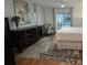 Bright main bedroom featuring a dark dresser, modern ceiling fan and an expansive, decorative area rug at 514 Palm Ave, Nokomis, FL 34275