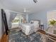 A bedroom with a ceiling fan features a cozy rug and sliding glass doors to the patio and pool area at 514 Palm Ave, Nokomis, FL 34275