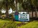 Entrance sign to Venice Beach surrounded by lush tropical foliage at 514 Palm Ave, Nokomis, FL 34275