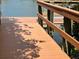 Wooden walkway that leads to a dock over calm water and nearby foliage at 147 Tampa E Ave # 202, Venice, FL 34285