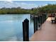 Scenic dock featuring wood surfaces and metal accents, extending into calm, clear water at 147 Tampa E Ave # 202, Venice, FL 34285