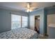 Comfortable bedroom with great natural light, coastal themed decor, wood-look floors, and a ceiling fan at 428 Boxwood Dr, Venice, FL 34285