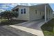 Charming home with a screened-in porch, carport, and a well-maintained front lawn on a sunny day at 428 Boxwood Dr, Venice, FL 34285