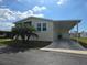 Charming home with a screened-in porch, carport, and a well-maintained front lawn on a sunny day at 428 Boxwood Dr, Venice, FL 34285