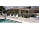 Community pool with lounge seating, shade, and manicured landscaping around the pool deck at 428 Boxwood Dr, Venice, FL 34285