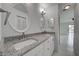 Well-lit bathroom featuring a double vanity with granite countertops, dual sinks, and modern fixtures at 766 Avenida Estancia # 196, Venice, FL 34292