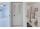 Bright bathroom featuring a closet with in-unit washer/dryer, toilet, shower, and coastal-themed decor at 766 Avenida Estancia # 196, Venice, FL 34292
