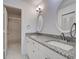 Bright bathroom with a double sink vanity featuring granite countertops and modern lighting at 766 Avenida Estancia # 196, Venice, FL 34292