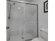 Bathroom featuring tile floors, step-in shower, and white fixtures at 766 Avenida Estancia # 196, Venice, FL 34292