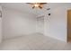 Bedroom featuring tile floors, a ceiling fan, and wall-mounted media setup at 766 Avenida Estancia # 196, Venice, FL 34292