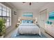 Serene bedroom featuring a queen bed with beach-themed decor, a window, and a closet at 766 Avenida Estancia # 196, Venice, FL 34292